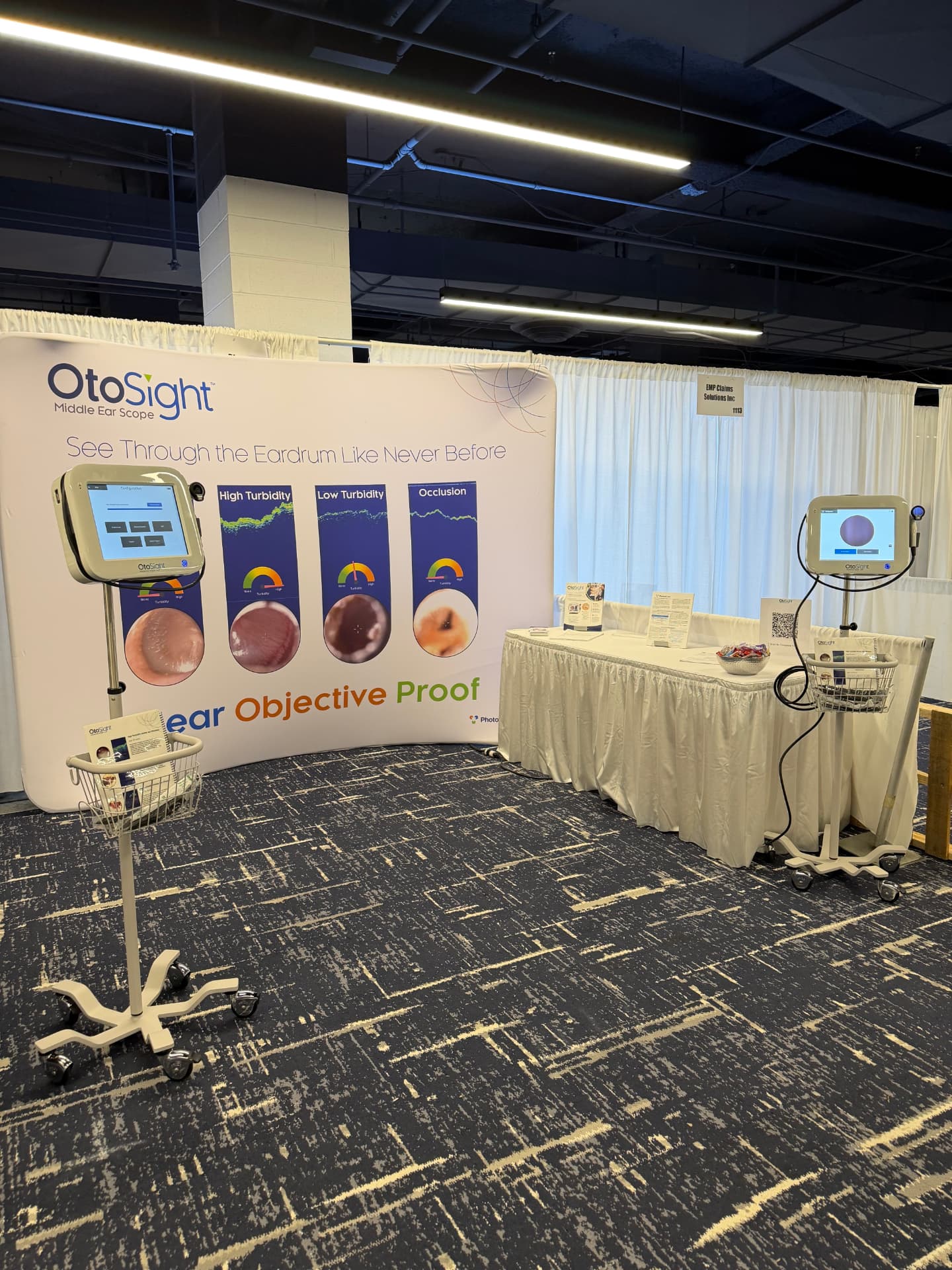 OtoSight trade show booth with two scopes and turbidity display banner