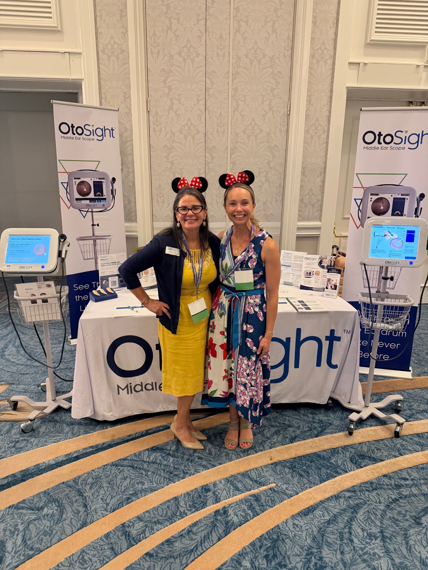 PhotoniCare team at an OtoSight conference booth
