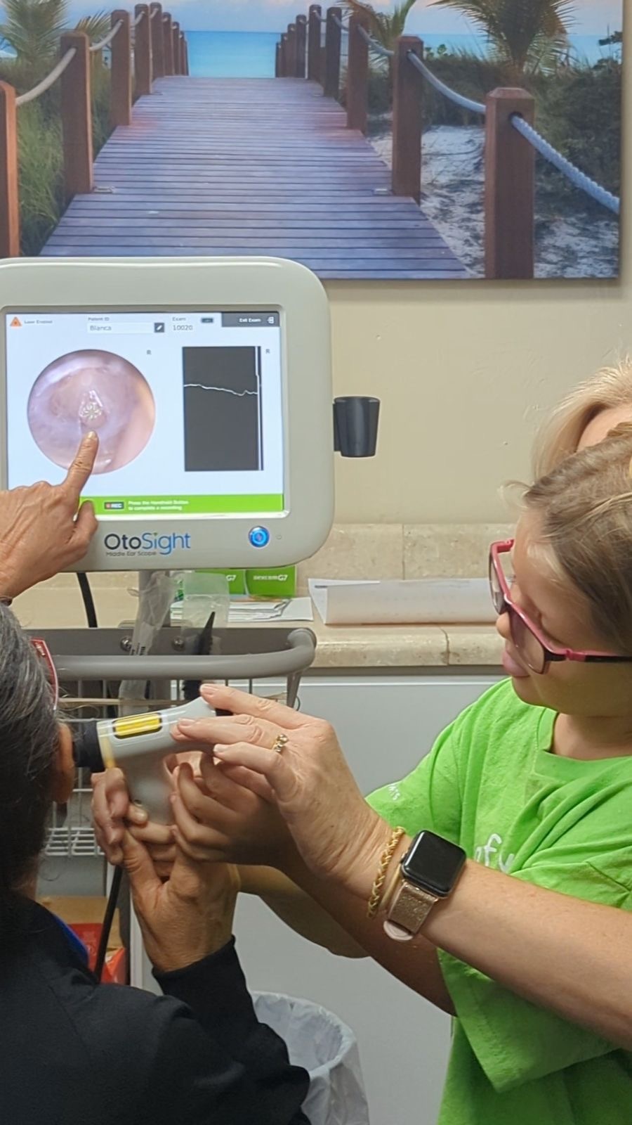 Provider showing a patient the middle ear scan on the OtoSight screen